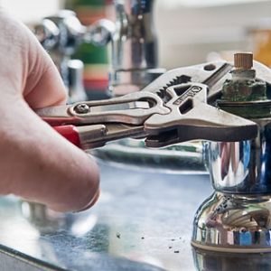 Real life situation - A plumber uses adjustable grips to remove a worn insert from a set of commercial kitchen taps with a view to replace the damaged part.